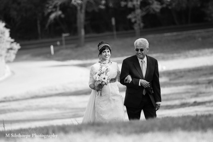 The bride and her father ascending the hill