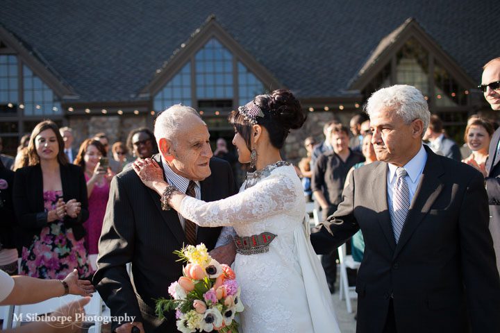 Kisses for grandpa and dad at the altar
