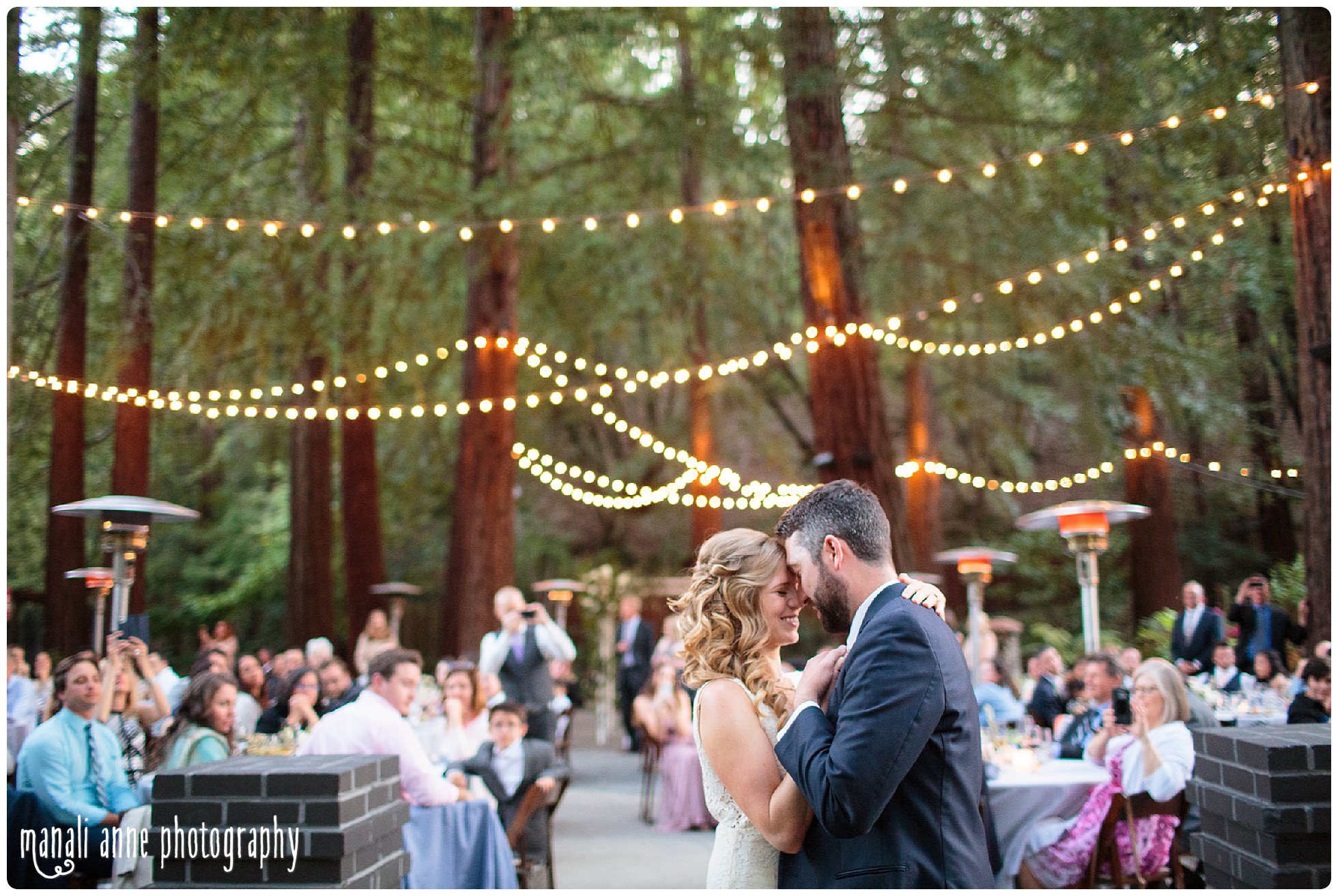 Newlyweds share their first dance under string lights and redwoods at Deer Park Villa