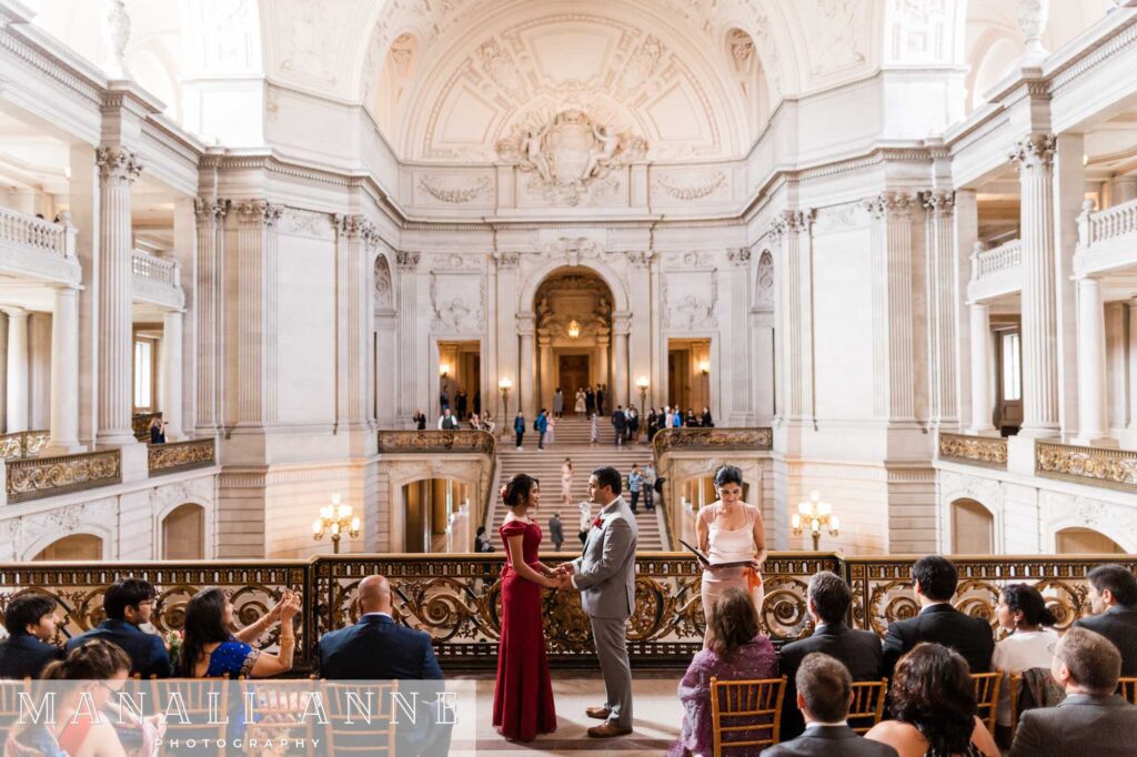 A couple gets married during a Private Ceremony on the Mayor's Balcony of San Francisco City Hall
