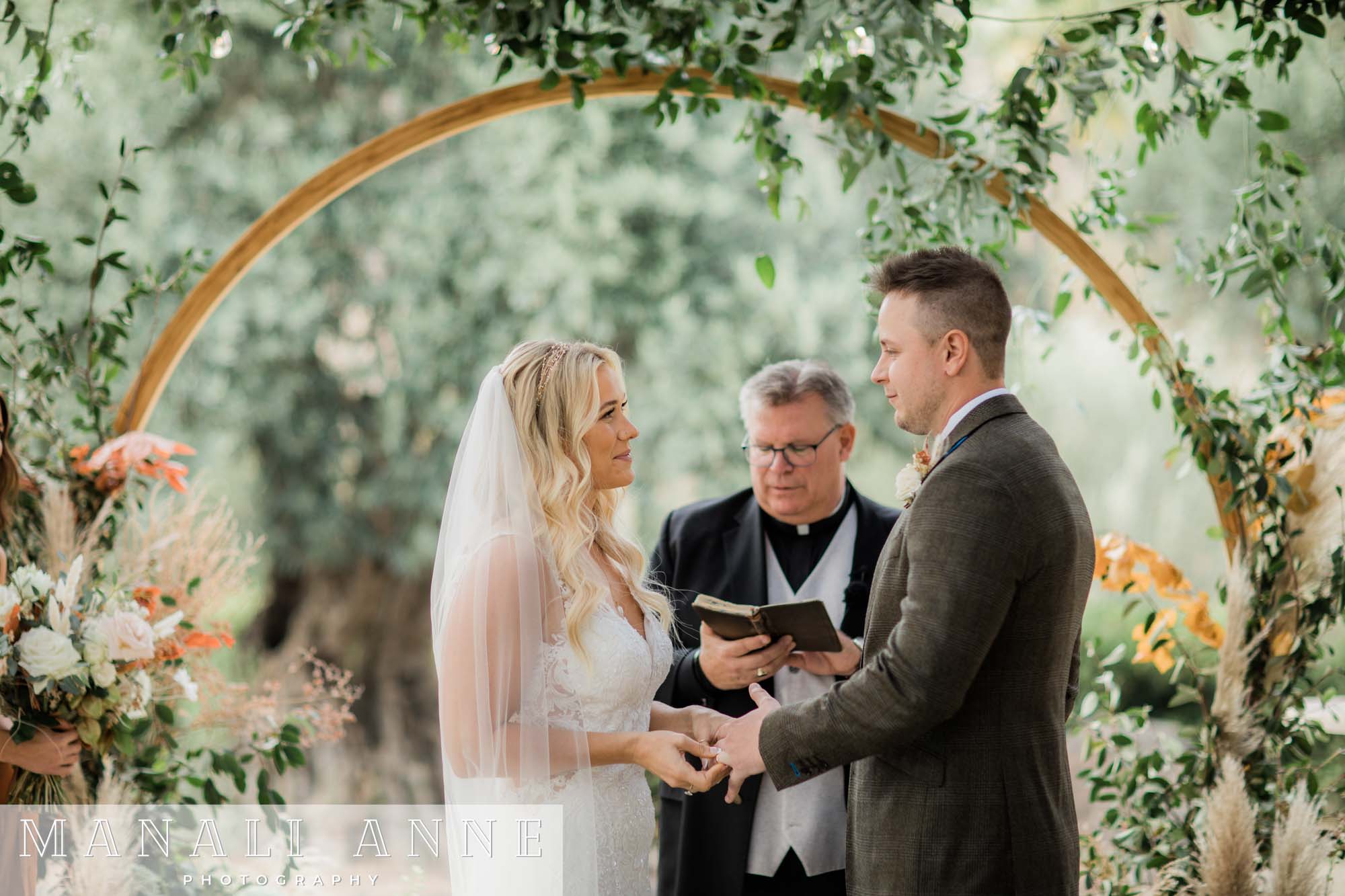 Wedding couple exchanging vows at Chateau St. Jean Winery 