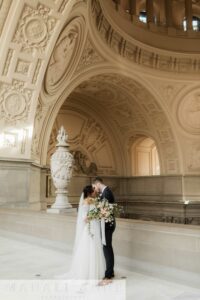 San Francisco City Hall Wedding couple holding each other on the Fourth Floor North Gallery