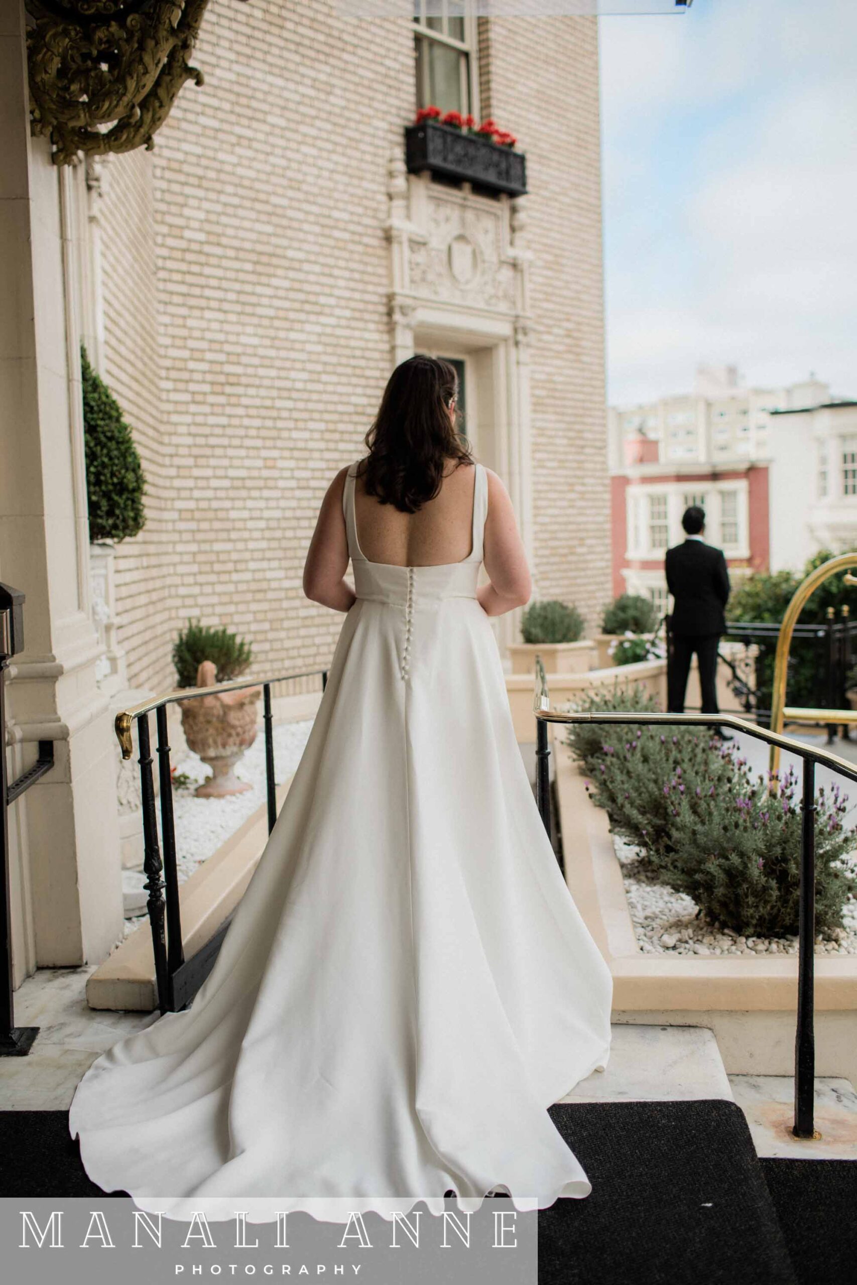 Bride and groom have a first look outside of the Mark Hopkins hotel on their wedding day