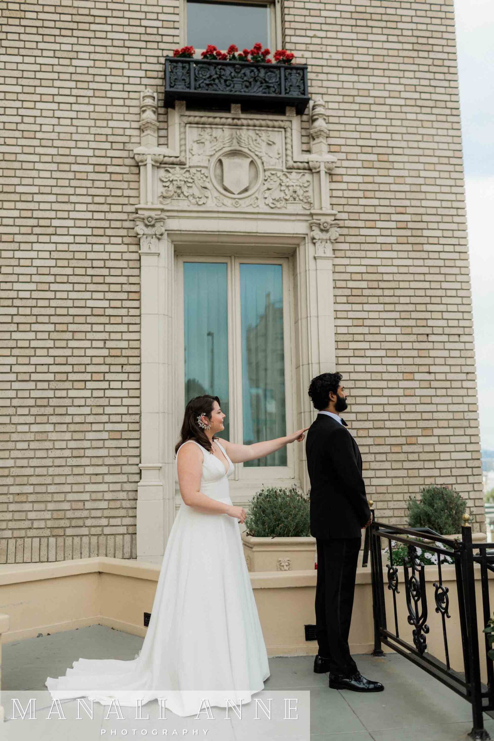 Bride and groom have a first look outside of the Mark Hopkins hotel on their wedding day