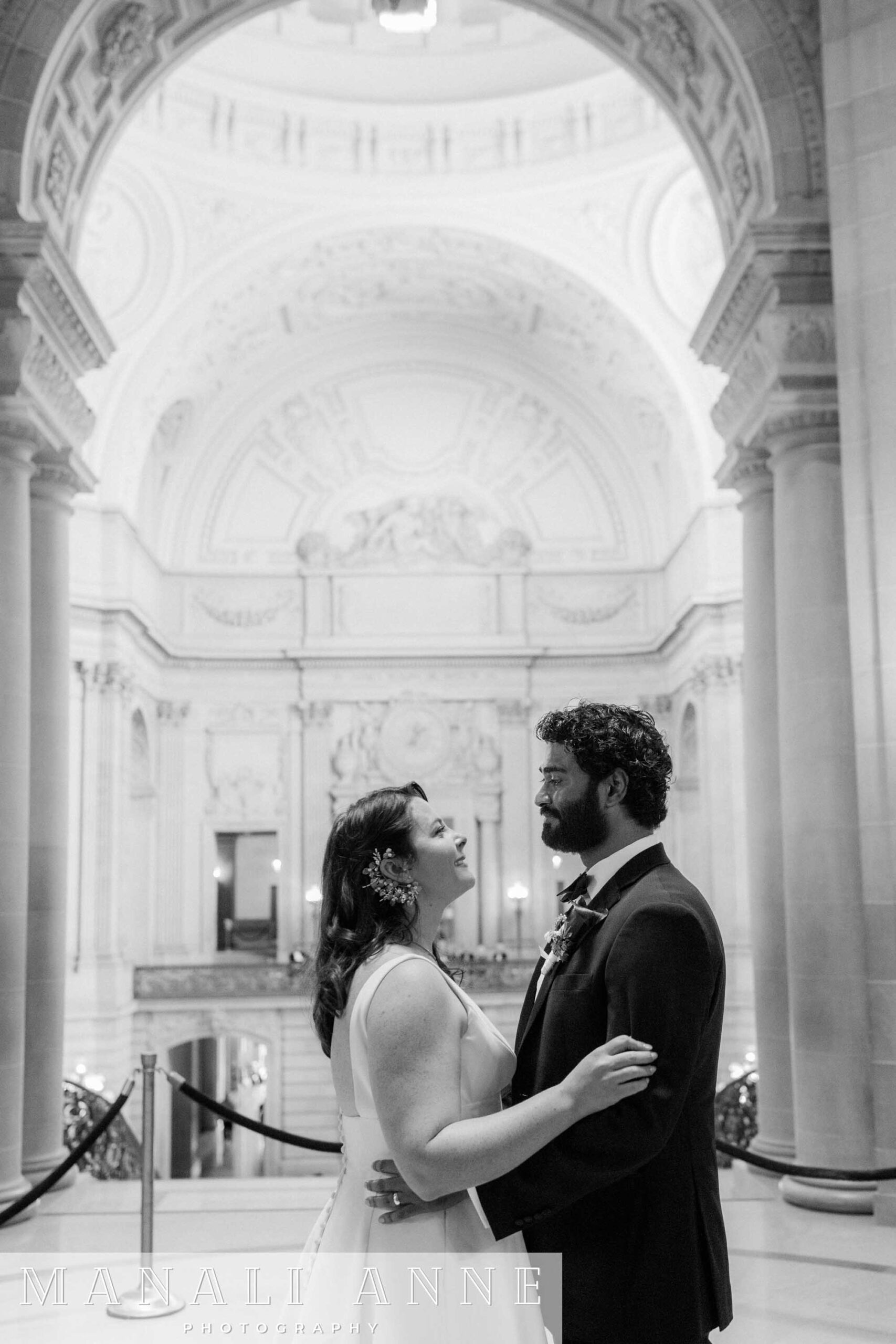 A wedding couple getting married at the rotunda during a civil ceremony at San Francisco city hall