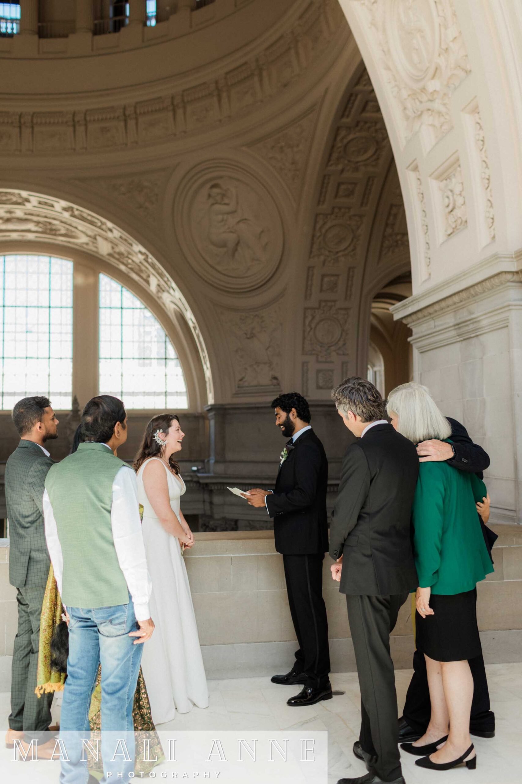 A couple exchanging private wedding vows on the 4th floor of San francisco city hall