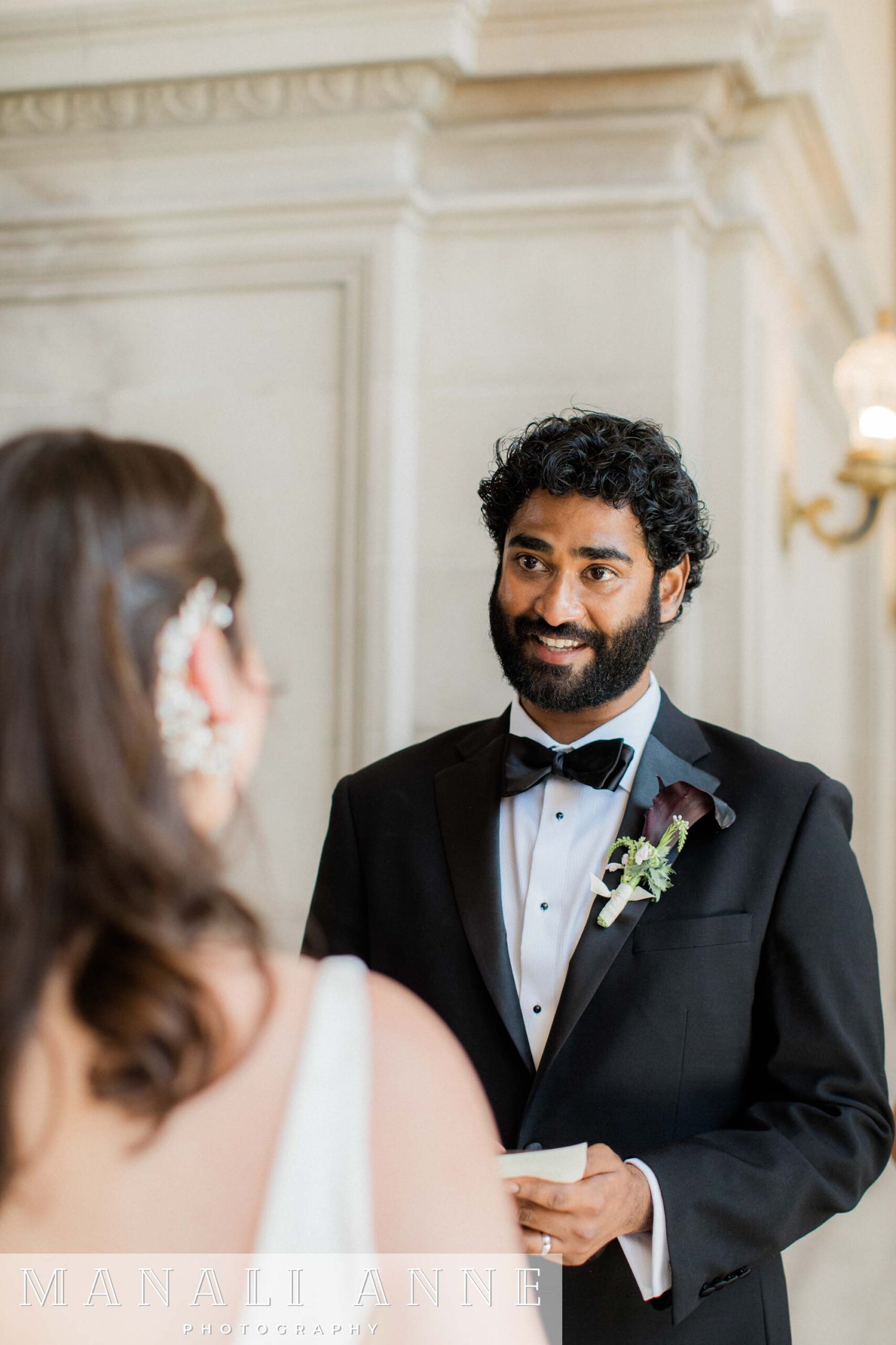 A couple exchanging private wedding vows on the 4th floor of San francisco city hall