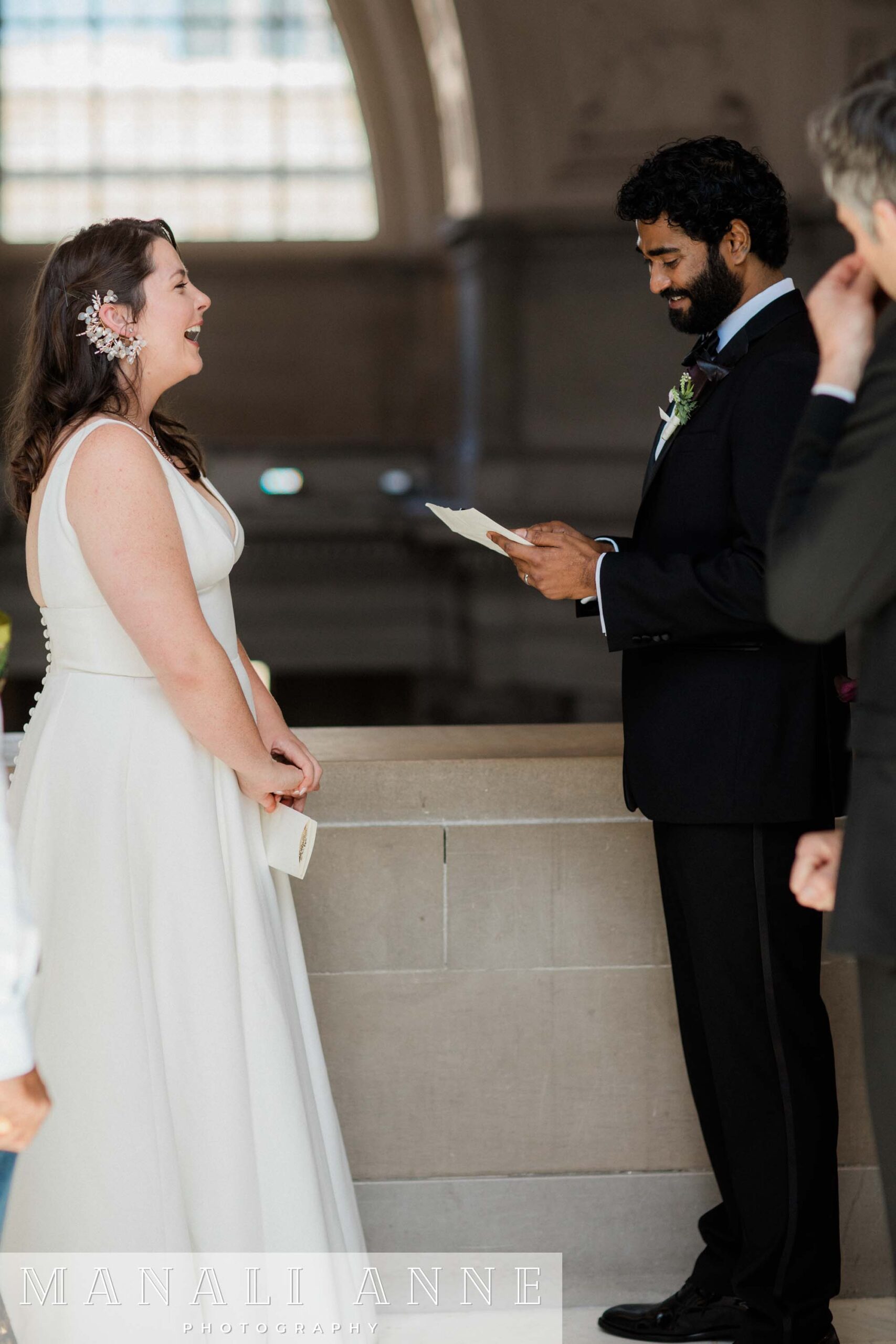 A couple exchanging private wedding vows on the 4th floor of San francisco city hall