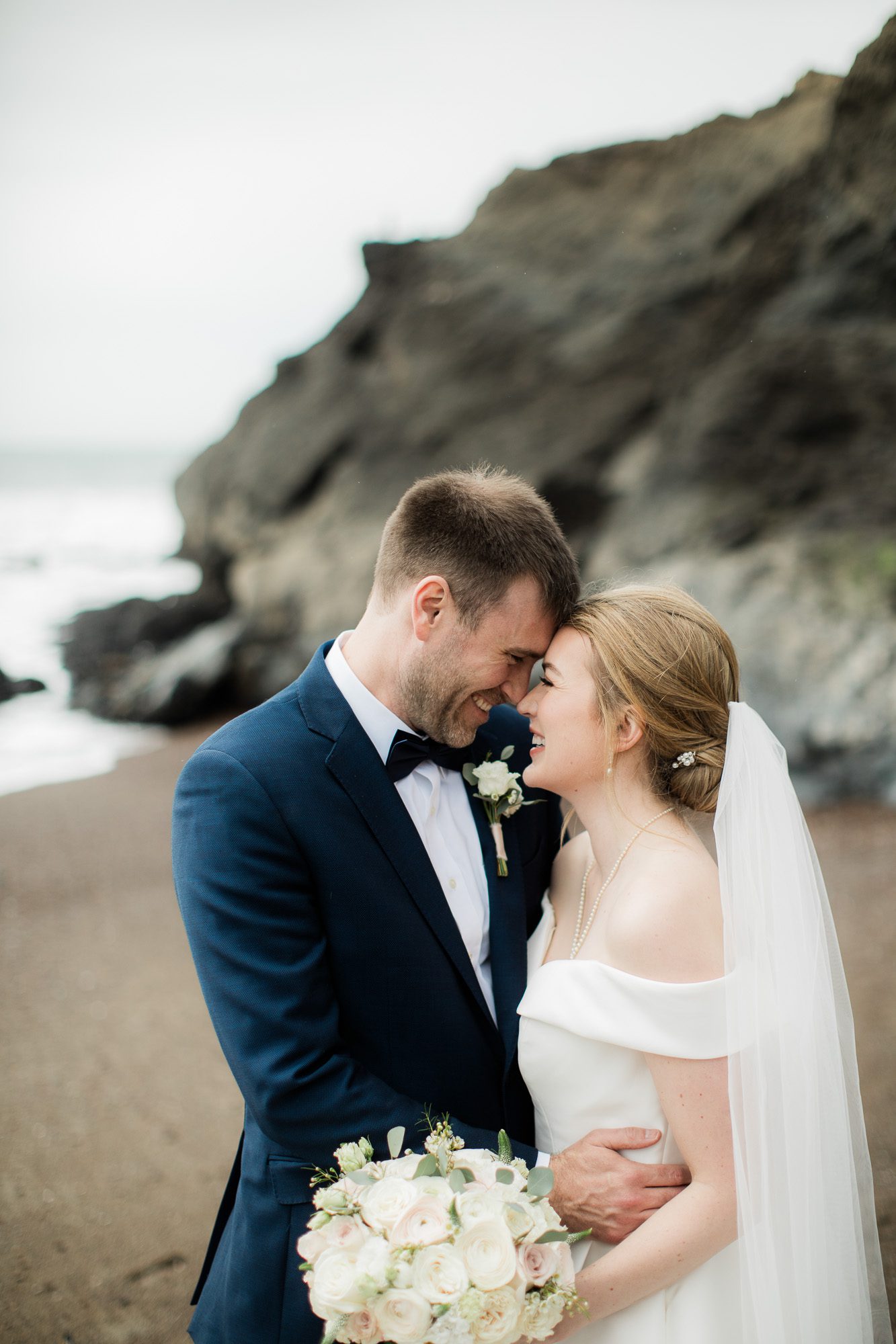 Bride and groom on the beach in california