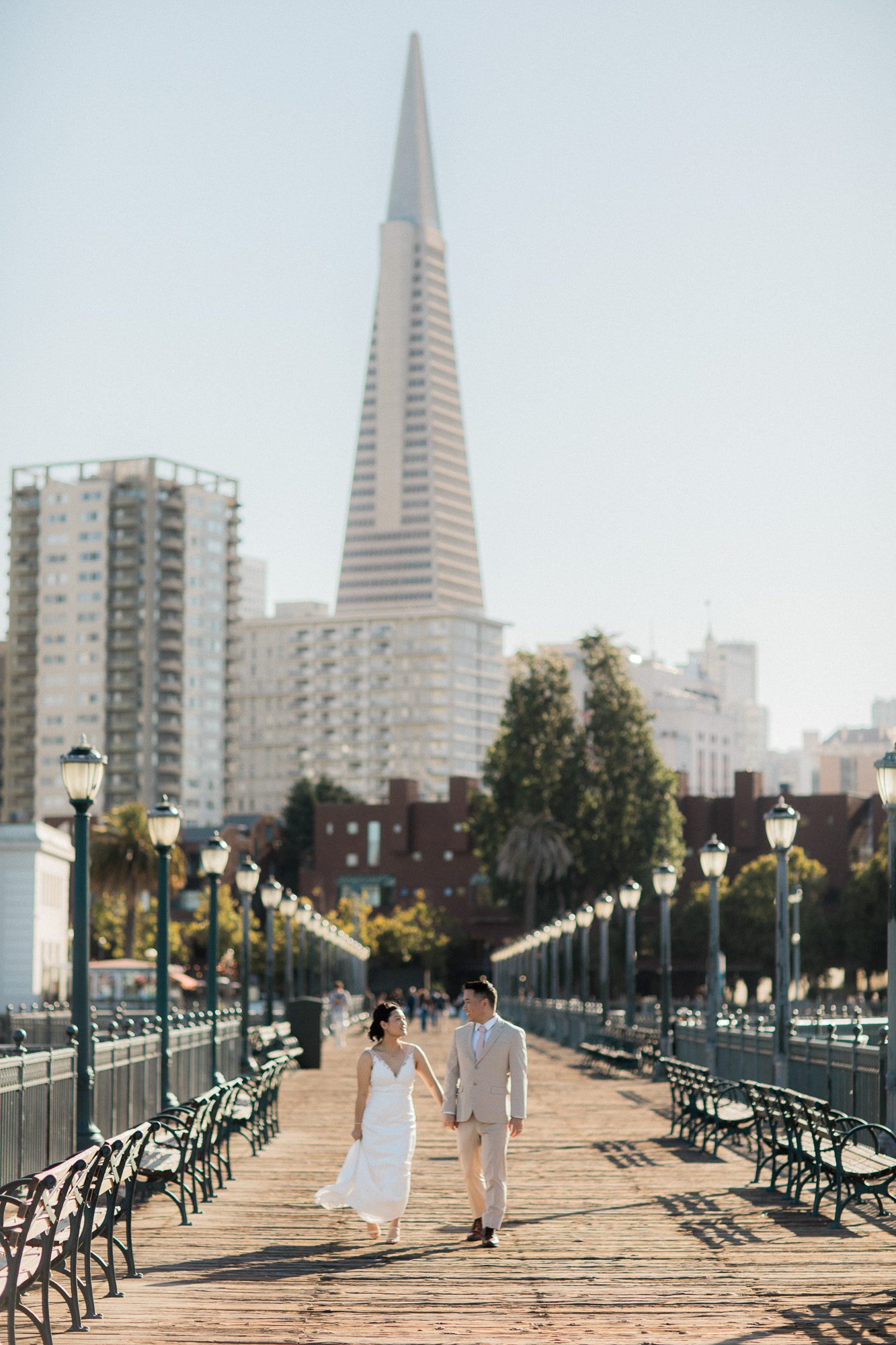 Couple walking down pier in San Francisco